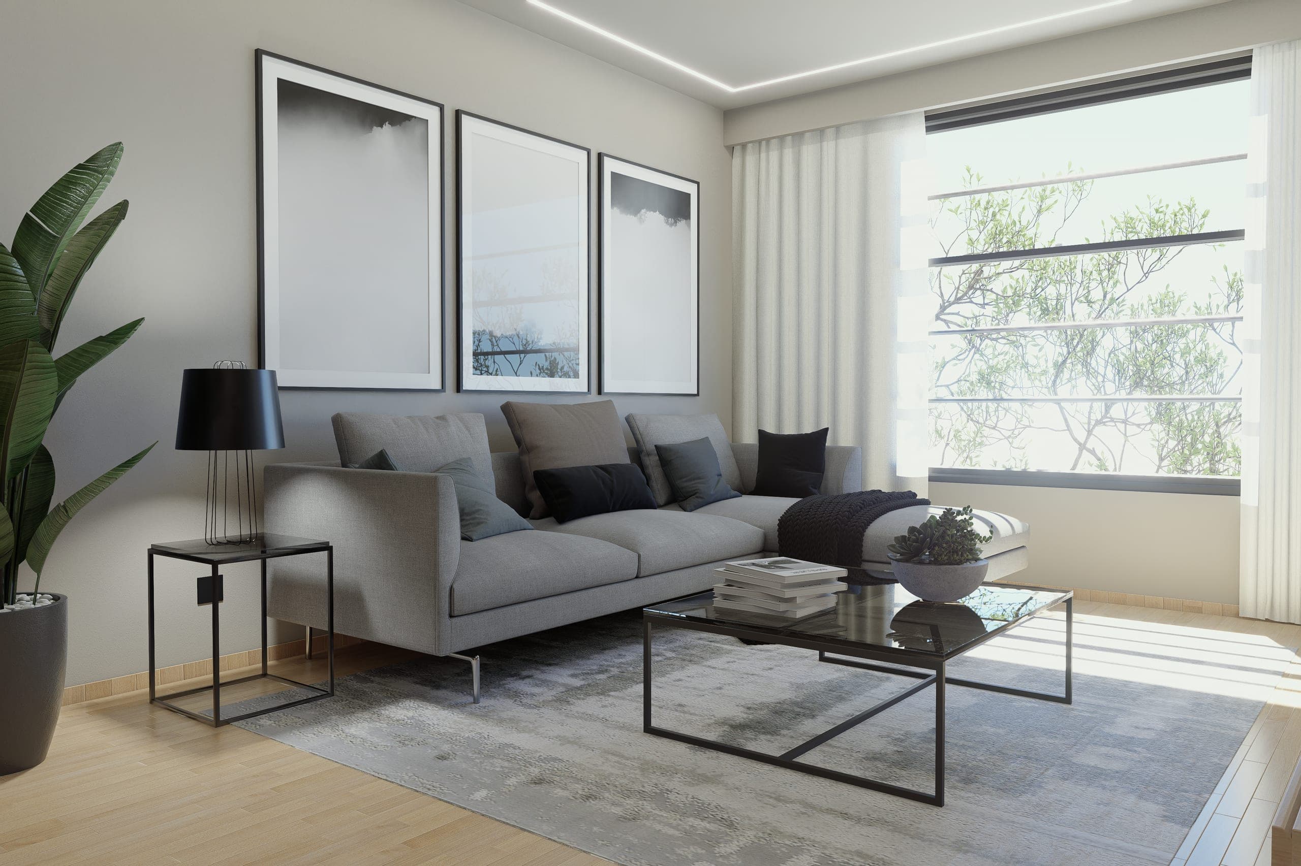 Salón con sofá modular gris, alfombra jaspeada y tres láminas abstractas enmarcadas en negro